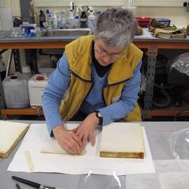 AHT Conservator Therese Charbonneau working on Aurora Australis paper