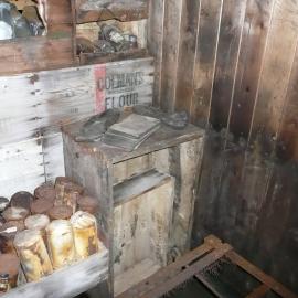 Bulkhead made of provision boxes and stocked with artefacts (002)