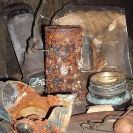 Corroded and rusted artefacts on radio table,  Scott's 'Terra Nova' Hut 