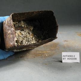 Before Treatment image - Corroded tin and contents