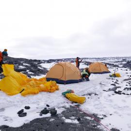 2017-18 Antarctic Heritage Trust conservation team members pitching Cape Royds field camp tents