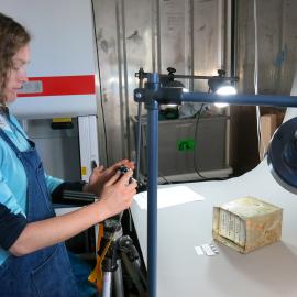 2013-14 Elana Hawke photographing artefacts, Scott Base