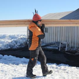 2018-19 Lizzie Meek carrying wood supplies, Cape Evans (002)