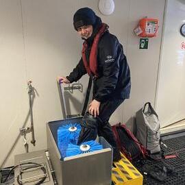 Inspiring Explorer Lily Green cleans her shoes on board the 'Magellan Explorer'