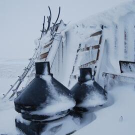 Snow build-up on flue parts and sleds on west wall (001)
