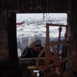 Heritage Carpenter Charley Brentnall looking through removed window, Cape Evans