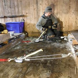 2013-14 Gord Macdonald working inside Scott's 'Discovery' hut, Hut Point 