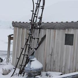 2022 Scott's 'Terra Nova' hut, exterior detail, West wall artefacts during snowfall