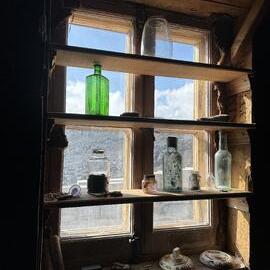 2025-26 Artefacts in the window, Shackleton's 'Nimrod' hut, Cape Royds